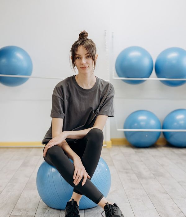 Woman in a calm yoga pose inside a glowing silver circle.